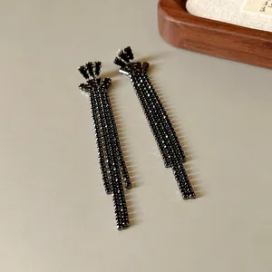 Detailed macro view of black rhinestone long tassel earrings featuring s925 silver needles