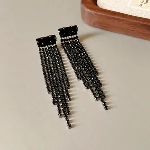Detail view of elegant black rhinestone long tassel earrings with silver needles