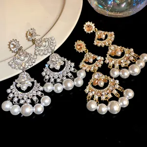 Macro view of vintage fan-shaped tassel earrings with pearls and shimmering crystals