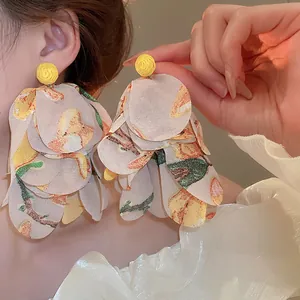 Elegant fairy-style chiffon flower tassel earrings with yellow woven studs for a sweet look.