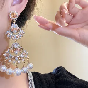 Elegant close-up of vintage fan-shaped chandelier earrings with pearls and crystals