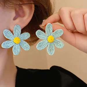 Handmade Bohemian woven flower stud earrings in light blue and yellow, vintage style