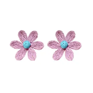Bohemian handmade woven flower stud earrings with purple petals and a blue center