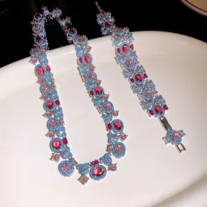 Close-up of vintage style necklace and bracelet with pink and blue zircon stones