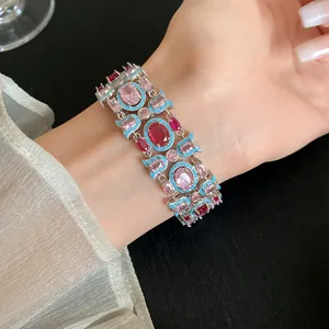 Detailed macro view of a luxury vintage style wide bracelet with pink and red zircons