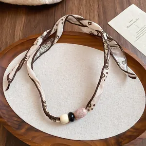 Elegant retro fabric scarf necklace featuring vintage patterns and ceramic beads