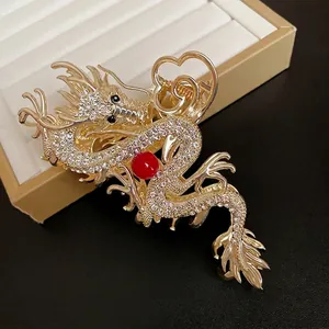 Elegant gold dragon hair claw clip with rhinestones and red bead in Chinese style