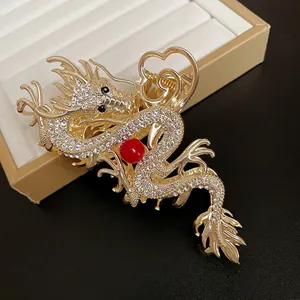 Exquisite gold dragon-shaped hair claw with sparkling rhinestones and a central red bead