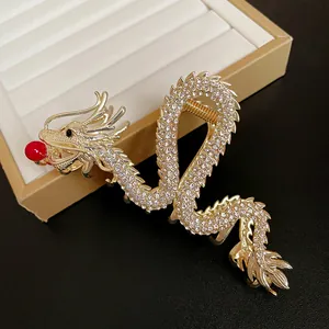 Close-up of exquisite gold Chinese dragon hair claw clip with sparkling rhinestone details