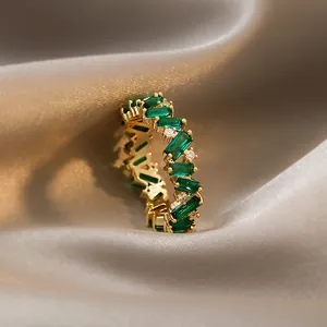 Detailed close-up view of vintage gold-plated ring featuring emerald green zircon stones
