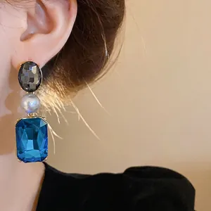 Vintage French style drop earrings with blue rectangular gemstone and white pearl detail.