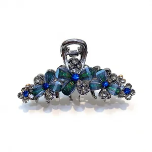 Elegant rhinestone floral hair claw clip featuring blue gems on a clean white background.