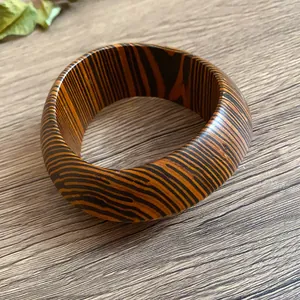 Close-up of retro tiger stripe pattern thick bangle bracelet on wooden desk