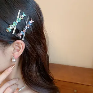 Detailed view of elegant rhinestone and resin flower hair clips on a brunette model