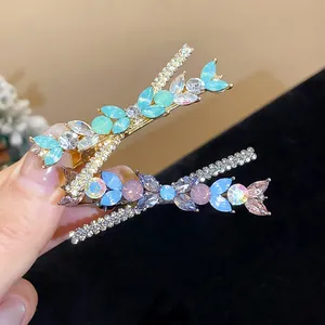 Close-up of elegant crystal and resin flower hair clips in blue and purple
