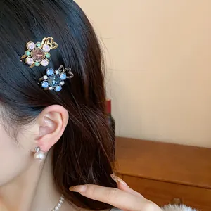Detail view of elegant floral rhinestone hair clips on model's hair