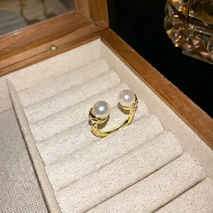 Vintage textured gold open ring featuring two elegant white pearls in jewelry box