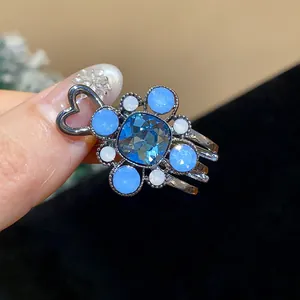 Macro view of an elegant blue crystal flower duckbill hair clip with rhinestones.