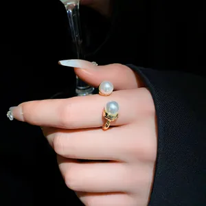 Elegant gold open ring with double pearl accents and a vintage pleated texture.