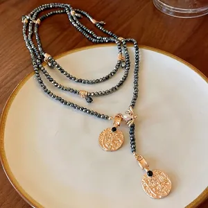 Vintage-style long beaded necklace with gold coin pendants and bee charm detail