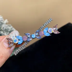 Close-up of elegant floral duckbill hair clip with sparkling multicolored rhinestones