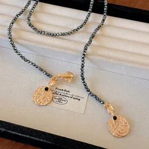 Vintage style gold coin and bee pendant long necklace with grey faceted beads for sweaters