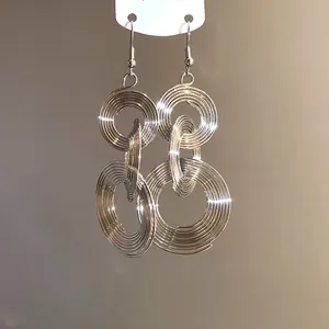 Detailansicht der silbernen Metallohrringe mit konzentrischen Kreisen und Haken