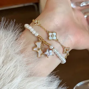 Elegant 18k gold plated pearl bracelet set featuring a horse charm and zircon clovers