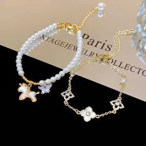 Elegant 18k gold plated pearl bracelet with unicorn charm and zircon clover chain