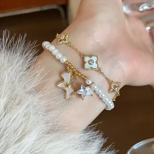 Close-up detail of 18k gold plated bracelet with a pearl strand and a zircon horse charm