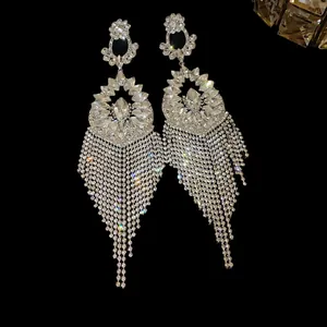 Close-up of luxury silver needle flower earrings with long crystal tassels