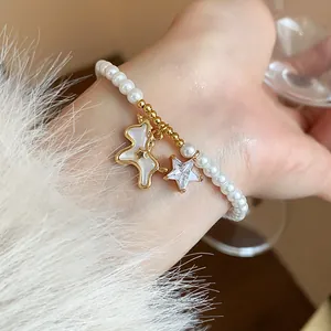 Detailed macro shot of an elegant pearl bracelet with gold-plated pony and star charms