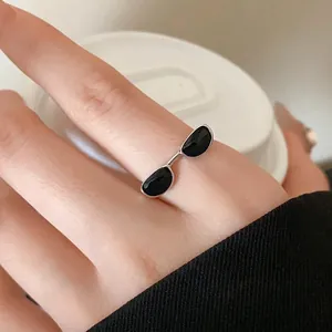 Minimalist sunglasses shaped adjustable open ring with black enamel drip finish.