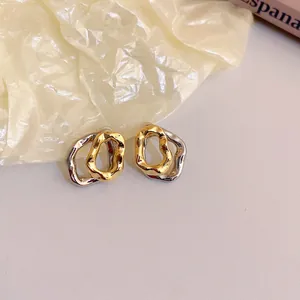 Modern two-tone twisted square geometric stud earrings with a textured metallic finish