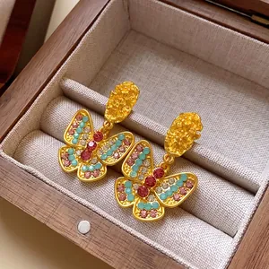 Vintage gold butterfly drop earrings with colorful rhinestones in a wooden gift box