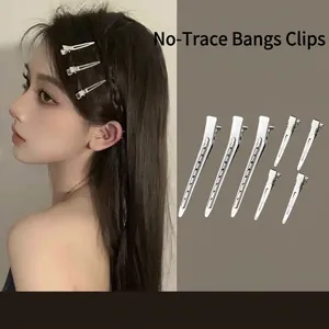 Vista detallada de pinzas para el cabello de pico de pato plateadas para peinado profesional