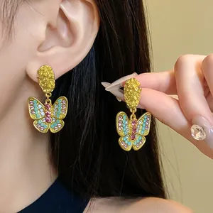 Detailed view of gold-tone vintage butterfly earrings with multicolored rhinestones