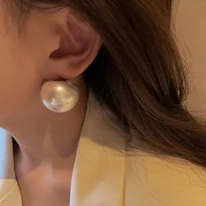 Primo piano di un orecchino a bottone con perla oversize in stile vintage francese