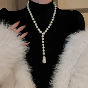 Elegante collana di perle a forma di Y con grande pendente a goccia indossata su lupetto nero