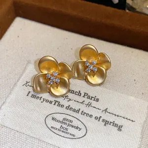 Exquisite French vintage gold flower stud earrings with sparkling central zircon stones