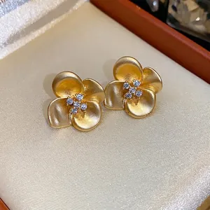 Elegant French vintage matte gold flower stud earrings with sparkling zircons
