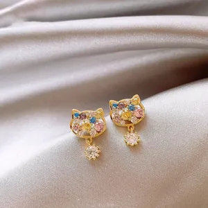 Close-up of 18k gold plated cat earrings with multicolored zircon and silver needle