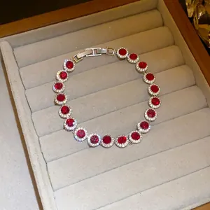 Elegant silver-toned bracelet featuring sparkling round red zircon stones in pave setting