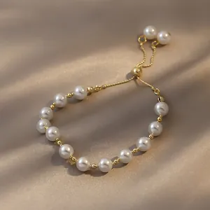 Elegant handcrafted pearl bracelet featuring an adjustable gold-tone sliding clasp closure