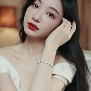 Detailed view of an elegant white pearl bracelet worn on the wrist of a young Asian model