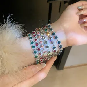 Close-up of vibrant colorful zircon bracelets with sparkling round stones on wrist
