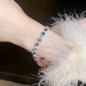 Detail shot of a sparkling bracelet with vibrant round multi-colored zircons.