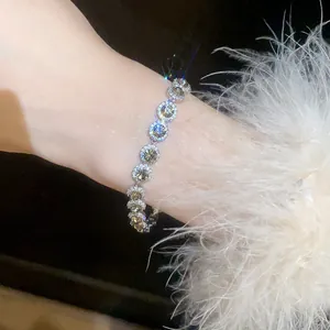 Close-up of shiny silver bracelet with multi-colored round cubic zirconia stones on wrist