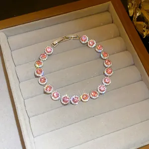 Detailed view of a sparkling pink cubic zirconia round halo bracelet in a jewelry box