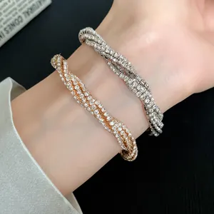 Close-up detail showing sparkling gold and silver multi-layer rhinestone wrap bracelets on wrist